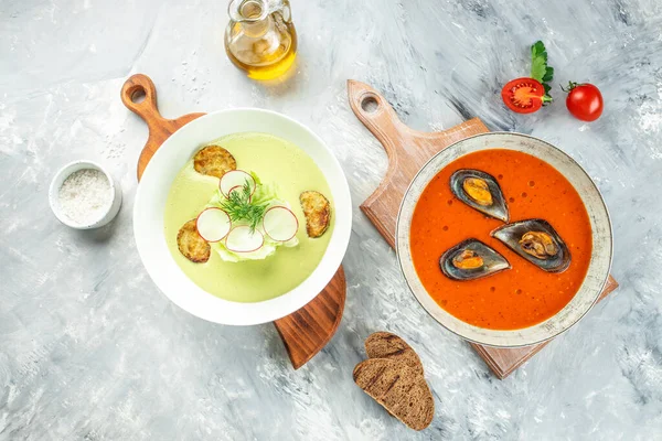 stock image set vegetable soup. tomato soup with mussels and zucchini soup. Healthy food concept. place for text, top view.