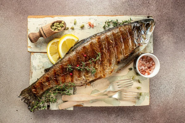 stock image Roasted trout with lemon. Grilled trout, organic healthy products. Detox and clean diet concept,