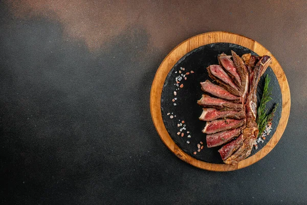 Stock image Marbled beef steak medium rare on a dark background. Healthy fats, clean eating for weight loss. top view. place for text.