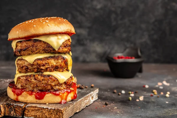 stock image Burger with Double cutlet, double cheddar cheese, sauce and craft bun. fast food and junk food concept.