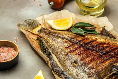 Baked Flounder Fish with herbs and lemon, Delicious balanced food concept, Restaurant menu, dieting, cookbook recipe top view,