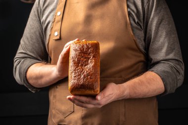 Erkek eli ekmek tutuyor. evcilleştirilmiş fırın pastası. Sağlıklı gıda konsepti. metin için yer.