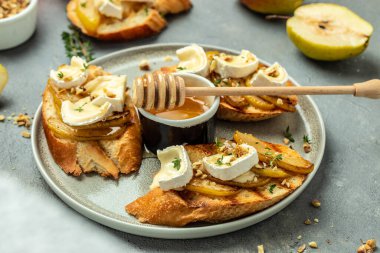 Sweet toast with pear, cheese and honey. party appetizer. banner, menu, recipe place for text, top view.