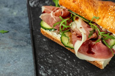 Delicious appetiser Italian prosciutto and Spanish Iberian ham snack. Delicious breakfast or snack, top view.