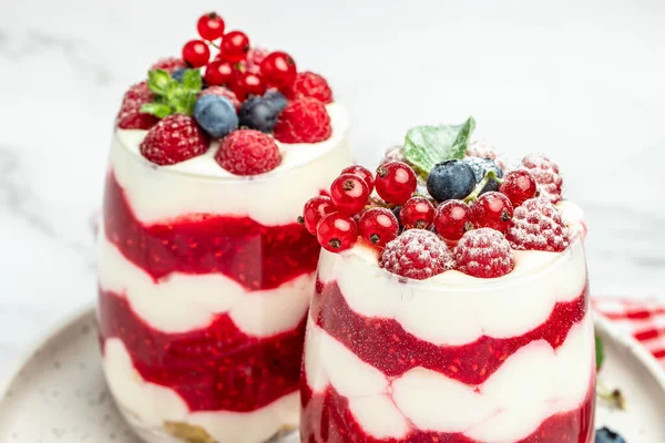 Cranachan raspberry dessert in jar on a blue background. banner, menu, recipe place for text, top view.