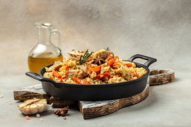 Uzbek pilaf in cast-iron pan. banner, menu, recipe place for text, top view.