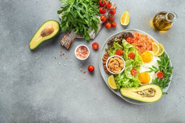 Sağlıklı beslenen sebze salatası, avokado, balık, yumurta, fıstık ezmesi. Düşük karbonhidrat keto ketojenik diyet,