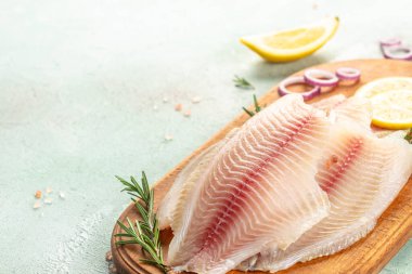 raw fish fillet white Tilapia on a light background. top view. clipart