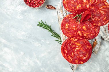 Traditional spanish sausage chorizo on a wooden board. banner, menu, recipe place for text, top view.