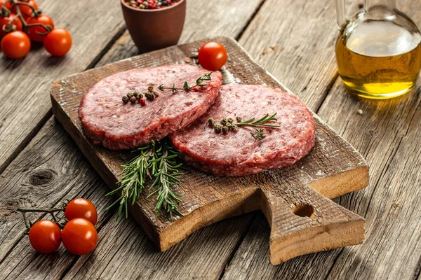 stock image Fresh raw meat cutlets on a wooden background, banner, menu, recipe place for text, top view,