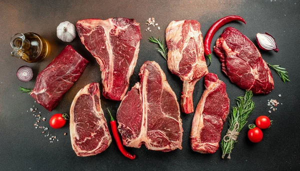 stock image Variety of Raw Black Angus Prime meat steaks T-bone, tomahawk, New York steak. Set raw marbled beef strip loin steaks. place for text, top view.