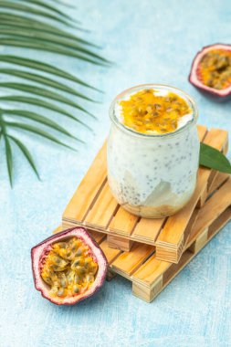 Milkshake with passion fruit in a light sunny background, Tropical drink for summer party.