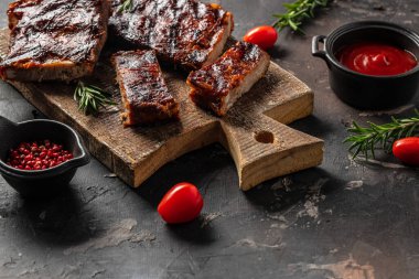 grilled and barbecue ribs pork on a wooden board, banner, menu, recipe place for text, top view.