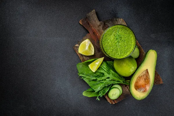 stock image green fresh smoothie on dark background. Detox, dieting, clean eating on a dark background. place for text,