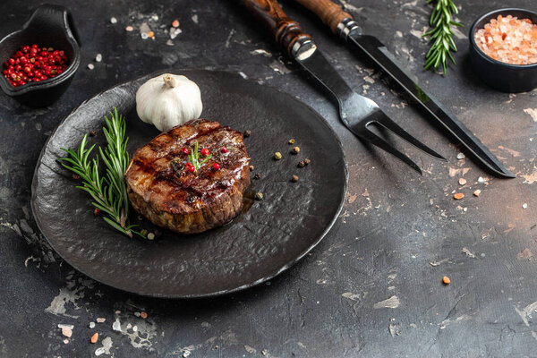 grilled meat barbecue steak on a wooden board. banner, menu, recipe place for text, top view.