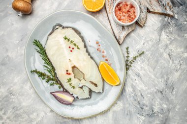 Fillet of fresh sea white cod fish steak Anarhichas on plate. banner, menu, recipe place for text, top view.
