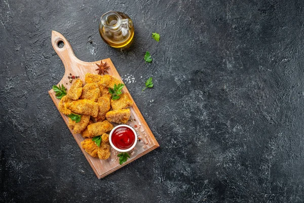 stock image fast food chicken nuggets with ketchup on a wooden board, banner, menu, recipe place for text, top view,