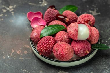 lychees, Ripe lychee. Exotic asian fruits on a dark background, Long banner format. top view,