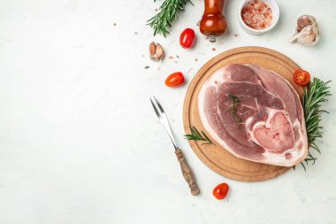 Slices of raw pork knuckle on a light background, Culinary cooking. banner, menu, recipe place for text, top view,