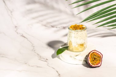 Milkshake with passion fruit in a light sunny background, Tropical drink for summer party.