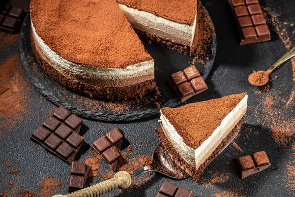 three chocolates cake. mousse cake on a dark background. Food recipe background. Close up.