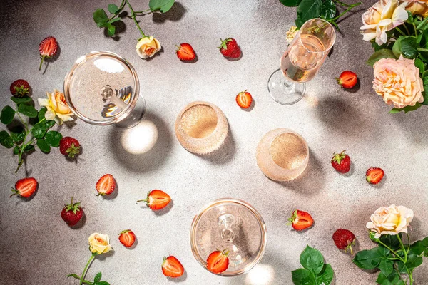 Glasses of delicious strawberry wine with roses, banner, menu, recipe place for text, top view,