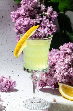 Geleneksel ev yapımı limonata limoncello açık arkaplanda çiçek açan leylak rengi.,