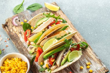 Kızarmış tavuk, avokado, taze domates ve limonlu sağlıklı mısır tortillası. metin için yer, üst görünüm.