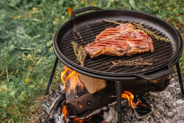 Beef steaks on the grill with flames. banner, menu, recipe place for text, top view.