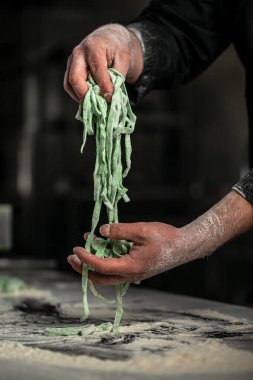 chef makes fresh spaghetti, fettuccine or tagliatelle. cooking process.