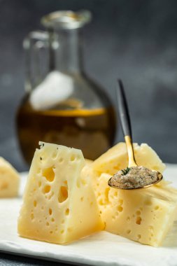 Pieces of delicious cheese with holes and truffle paste. vertical image. place for text.