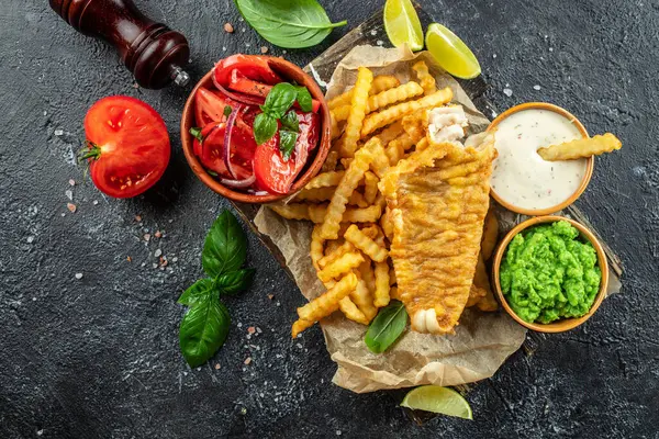 British Traditional Fish and chips with mashed peas, vegetable salad, tartar sauce, banner, menu, recipe place for text, top view,