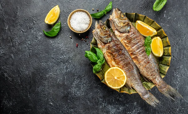 grilled seabass fish with lemon. Detox and clean diet concept. Long banner format. top view.