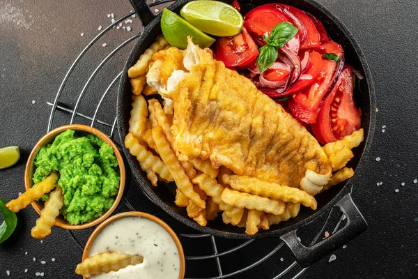 British Traditional Fish and chips with mashed peas, tartar sauce, Restaurant menu, dieting, cookbook recipe top view,