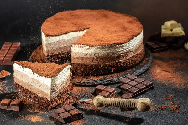 three chocolates cake. mousse cake on a dark background. Food recipe background. Close up.