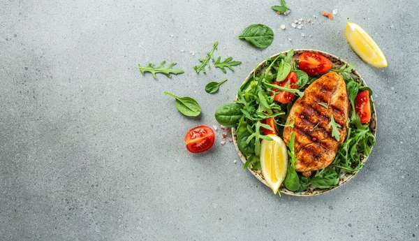 Grilled chicken breast with tomatoes and herbs, Healthy, clean eating. place for text, top view,