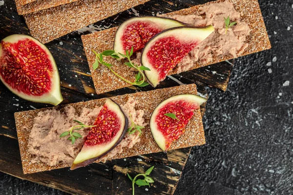 dry crusty bread with Liver pate and fig. Food recipe background. Close up.