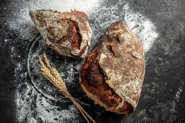 Rye floured bread on black background. Bakery product, Restaurant menu, dieting, cookbook recipe top view,