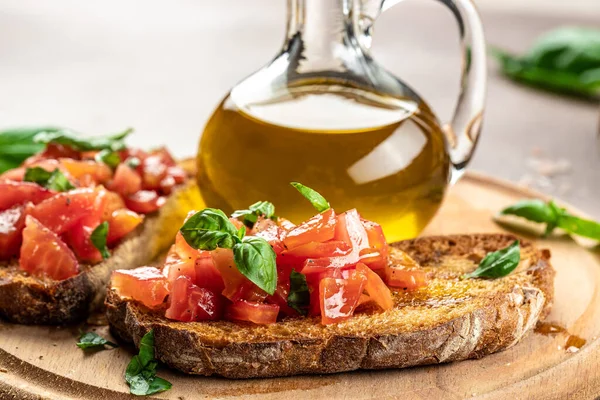 Italian tomato bruschetta with basil, garlic and olive oil on grilled or toasted crusty ciabatta bread, banner, menu, recipe place for text, top view,