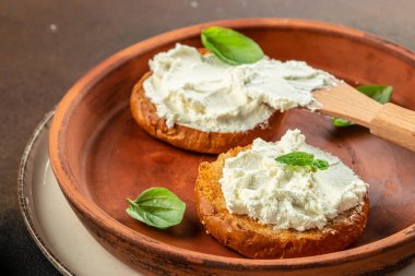 Krem peynirli kızarmış ekmek ve taze fesleğen yaprağı. Yemek tarifi geçmişi. Kapat..