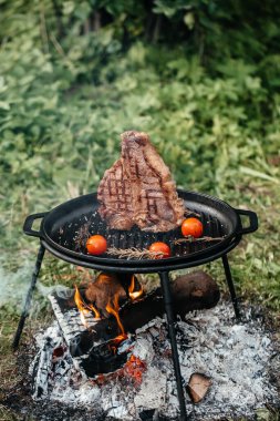 Biftek. Taze çiğ ana Angus bifteği dumanlı ızgarada pişiyor.,