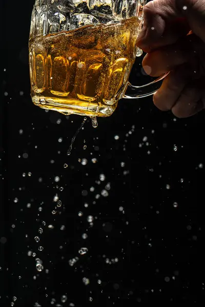 Beer with foam splash. Freeze motion splash drops of beer foam. vertical image. place for text.