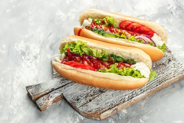 Delicious homemade hot dogs on a light background top view. copy space,