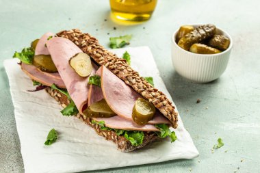 Jambonlu sandviç ve tabakta salatalık turşusu. Yemek tarifi geçmişi. Kapat..