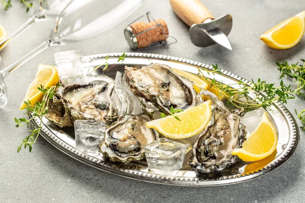 Oysters are protein rich and raw with lemon a delicacy on a light background top view. copy space,