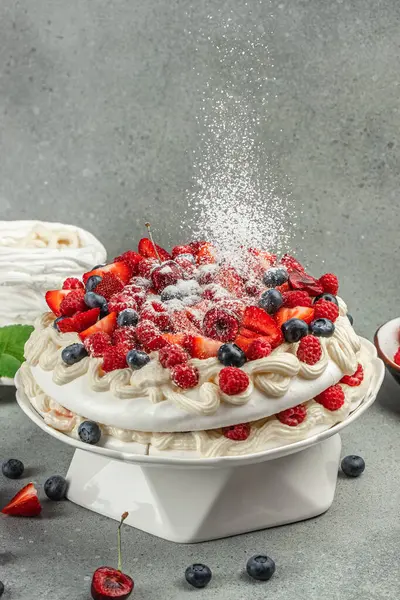 Pavlova cake with berries with topping with whipped cream and strawberries. culinary, bakery, food concept,