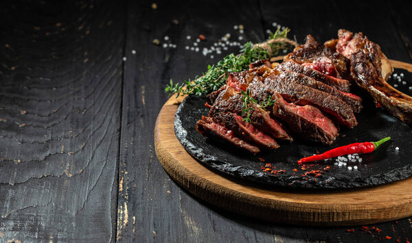 grilled beef barbecue Striploin steak on cutting board. Long banner format. top view. copy space for text.