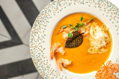 Lezzetli sarı balkabağı kremalı çorba, karides, restoran menüsü, diyet, yemek kitabı tarifi üst görünümü,