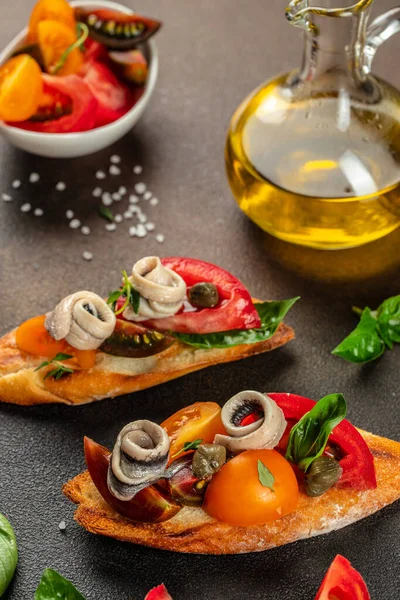 Bruschetta with marinated anchovies, fresh tomato, olive oil. Delicious spanish tapas. banner, menu, recipe place for text, top view.