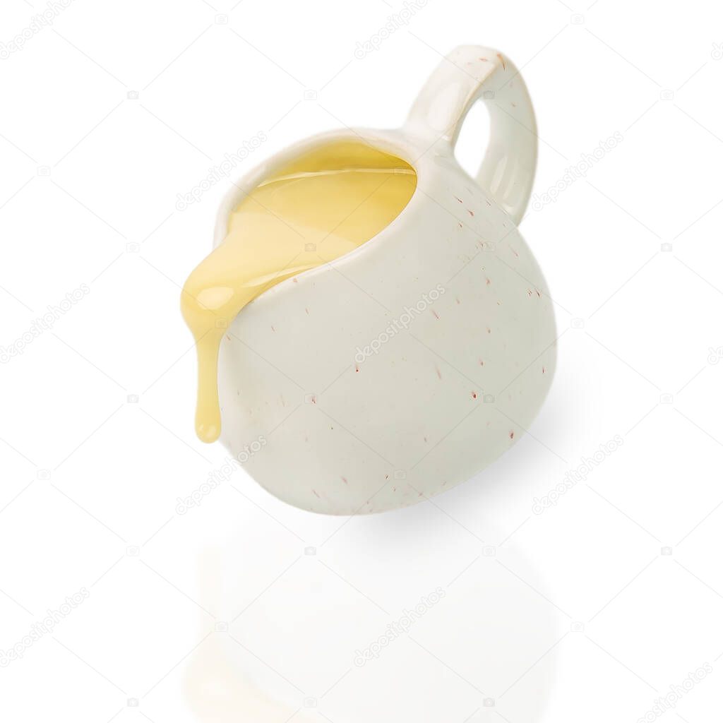 Pouring condensed milk in the jar isolated on white background,